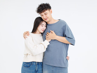 Portrait asian cute young couple love happy cheerful smile posing embracing in casual clothes hugging on white background studio together relationship good time sweet enjoy moment beautiful romantic.
