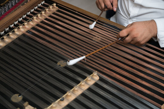 Musician playing traditional old dulcimer (cymbalo ). Retro music instruments  in Romania ,