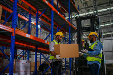 Blue collar workers are working at warehouse.