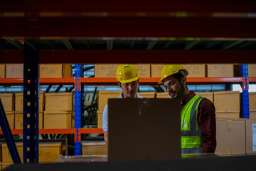 Blue collar workers are working at warehouse.
