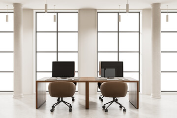 Naklejka premium Two computer desks with brown chairs in a modern empty office interior, large grid windows, minimal decor, white background, workspace concept, 3D Rendering