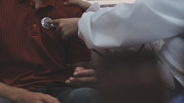 Doctor use stethoscope, checking up heart beat, auscultation in doctor office at hospital. Patient worker has to get medical checkup every year for her health or