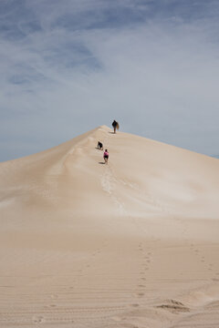 Children running up sand dune at Fowlers Bay
