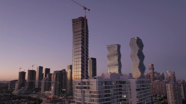 Mississauga skyline at sunset with modern high-rises and cranes visible