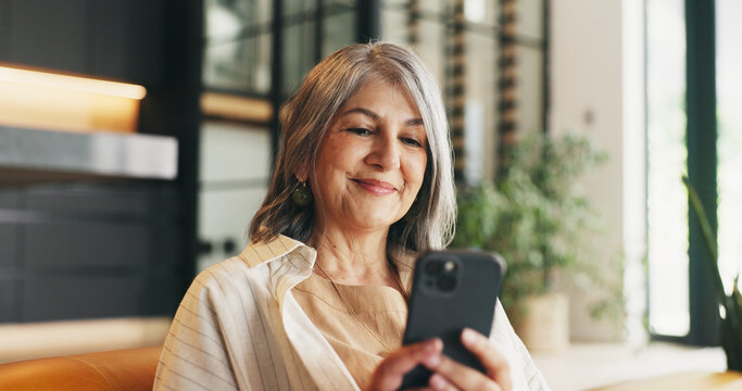 Home, smartphone and woman on couch, internet and message to contact, texting or relax. Communication, mobile user or mature person on sofa, cellphone or digital app for social media or reading email