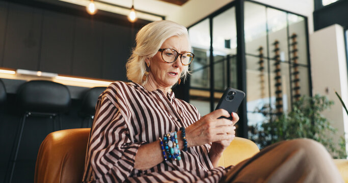 Home, smartphone and woman on sofa, low angle and message to contact, upset or mistake. Online reading, email or mature person with cellphone, phishing scam or app for social media or website info