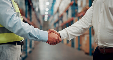 Business people, meeting and warehouse with handshake for partnership, b2b or deal in logistics. Employees, colleagues or shaking hands with agreement for storage control, shipping or supply chain © SparkPix/peopleimages.com