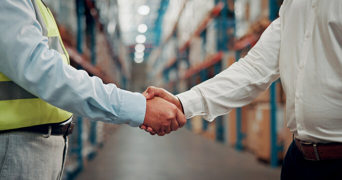 Business people, meeting and warehouse with handshake for partnership, b2b or deal in logistics. Employees, colleagues or shaking hands with agreement for storage control, shipping or supply chain