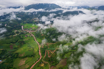 Landscape of Morning Mist with Mountain Layer. mountain ridge and clouds in rural jungle bush forest