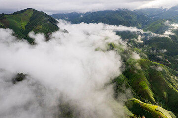 Landscape of Morning Mist with Mountain Layer. mountain ridge and clouds in rural jungle bush forest