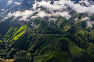 Landscape of Morning Mist with Mountain Layer. mountain ridge and clouds in rural jungle bush forest