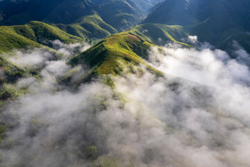 Landscape of Morning Mist with Mountain Layer. mountain ridge and clouds in rural jungle bush forest