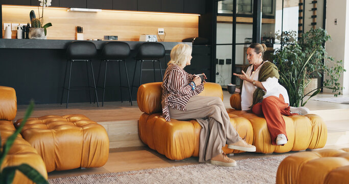 Friends, women and discussion with coffee on couch, storytelling and weekend visit for connection. Home, gossip session and mature people with tea drinks for reunion, conversation and recall memory
