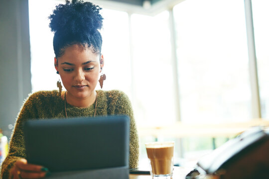 University student, girl and tablet with reading in cafe for online learning, study break and research. Education, african person and digital tech in restaurant for thesis review and college portal
