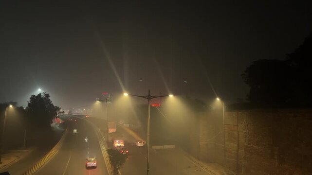 Shot of Traffic running on the road at night in Delhi, India
