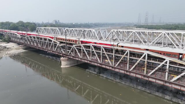 Aerial view of old iron bridge, Loha pul at Yamuna River in Delhi, Train is going on the bridge
