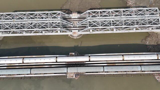 Aerial view of old iron bridge, Loha pul at Yamuna River in Delhi, Train is going on the bridge
