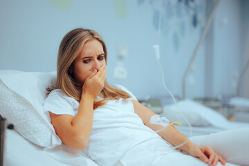 Patient Feels Nauseous Uses IV Drip Anti-emetic Treatment. Woman experiencing emesis receives...