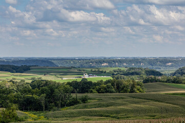 Fototapeta premium Rolling Hills and Farmstead with Contour-Farmed Fields