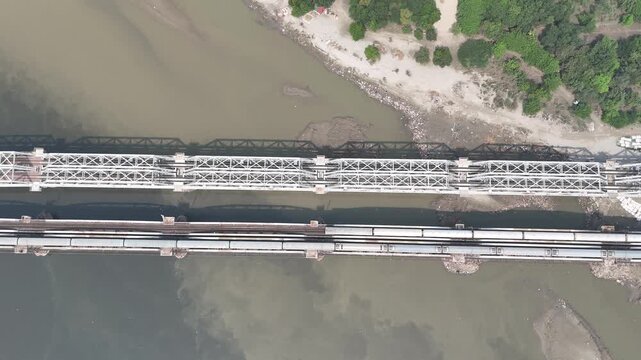 Aerial view of old iron bridge, Loha pul at Yamuna River in Delhi, Train is going on the bridge
