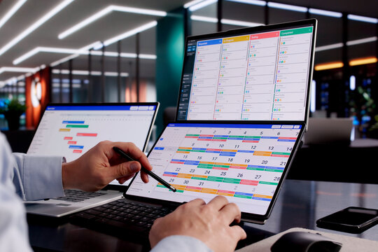 Professional Hispanic Manager Utilizing Calendar Software
