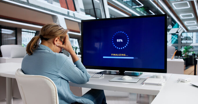 Woman Installing Latest Software Update On Her Computer System