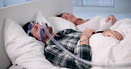 Man Sleeping Peacefully With CPAP Machine