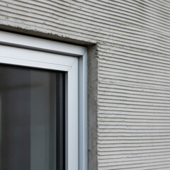 Modern architecture design highlighting minimalist window and textured wall concept. ideal for urban living and home improvement inspirations.