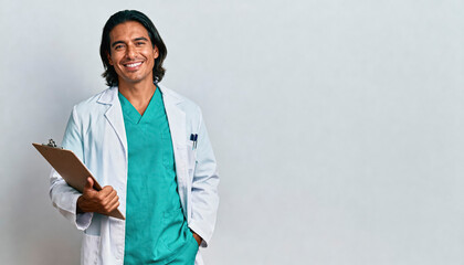 Charismatic latino male doctor in professional attire holding clipboard, emphasizing confidence and medical expertise
