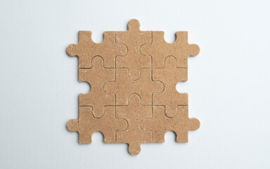 Obraz premium Empty wooden puzzle on a clean white background with copy space, suitable for advertising concepts, branding, marketing messages, and creative design.
