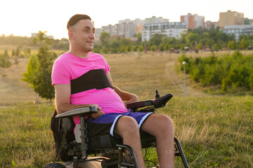 Obraz premium Portrait of a man with disability sitting in a wheelchair, expressing calm confidence.