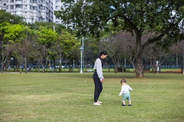 Baby running on the grass with mum