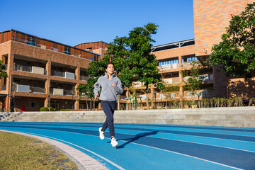 Young woman jogging on outdoor running track