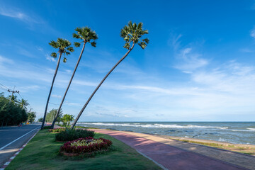 The iconic three leaning sugar palm trees landmark at Pak Nam Pran beach, Pranburi, Prachuap Khiri Khan, Thailand.