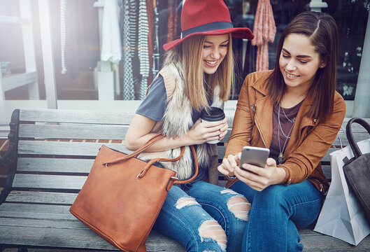 Shopping, women and smile with phone at mall for social media, internet browsing or discount. Friends, online sales and people with tech for mobile deals, promo codes or boutique store purchase