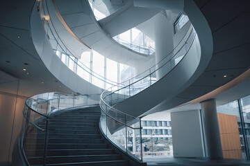 a spiral staircase in a building with a glass railing