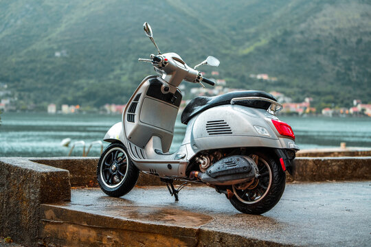 Silver moped by lakeside in countryside
