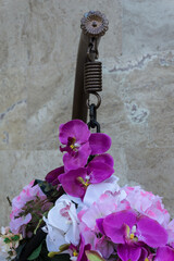 Detail from hanging chair decorated with artificial flowers