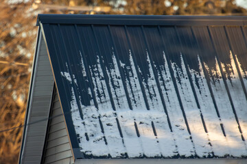 A metal roof with snow in winter