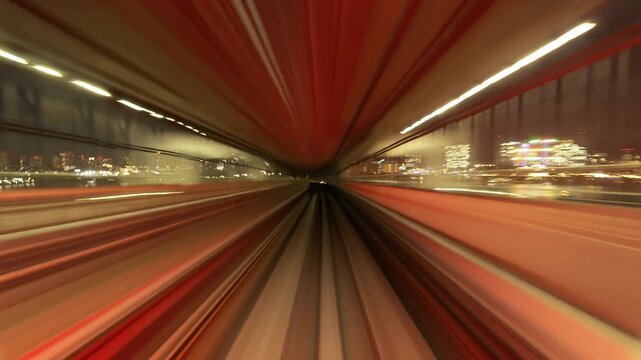 Futuristic motion blur through a high-speed transit tunnel in Tokyo at night.