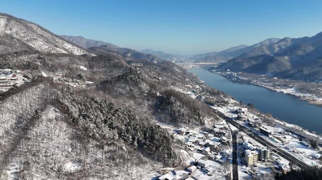 Drone footage, Winter landscape, river, mountain, village in Gapyeon city, South Korea