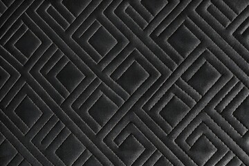 Naklejka premium black quilted faux leather fabric texture background with geometric stitching