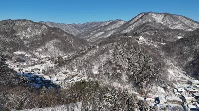 Drone footage, Winter landscape, river, mountain, village in Gapyeon city, South Korea