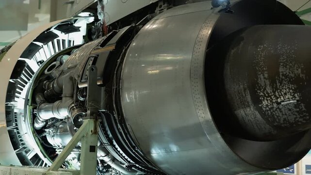 Detailed view of large jet engine with open service cowling.