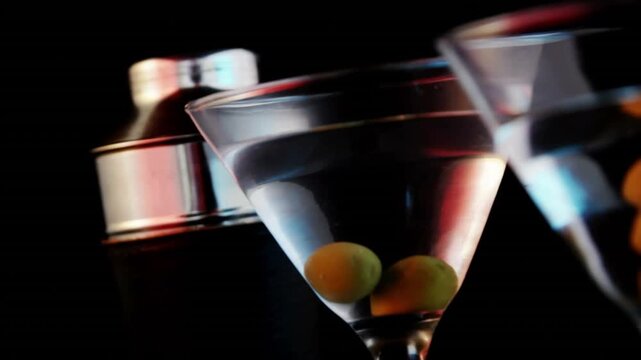 Video of glasses of martini on black background