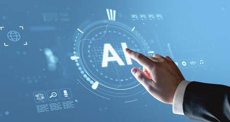 Businessman's hand touching AI interface on digital screen with tech hologram elements on futuristic concept blue background.
