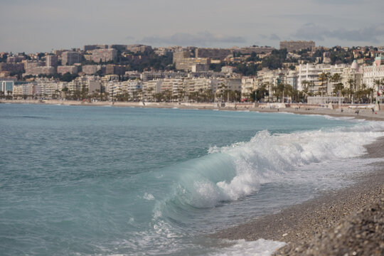 Morning waves on pebble beach in Nice, France