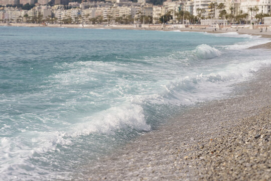Morning waves on pebble beach in Nice, France