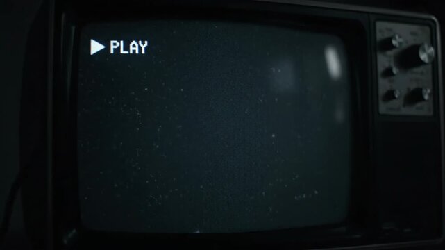 Retro TV Screen with Play Button and Static Glitch Effect.
