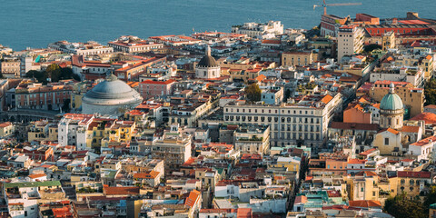 Obraz premium Naples, Italy. Top View Cityscape Skyline With Famous Landmarks And Part Of Gulf Of Naples With Ships In Sunny Day. Many Old Churches And Temples